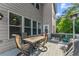 View of the outdoor dining area on the wood deck with a grill and outdoor heater at 4022 Roberts Crest Dr, Suwanee, GA 30024