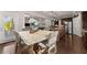 Bright dining area featuring light walls, hardwood flooring and view into the open kitchen at 4022 Roberts Crest Dr, Suwanee, GA 30024