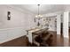 Elegant dining room featuring hardwood floors, wainscoting, and coffered ceilings at 4022 Roberts Crest Dr, Suwanee, GA 30024