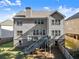 View of the rear of the home and the elevated deck with stairway to the yard at 4022 Roberts Crest Dr, Suwanee, GA 30024