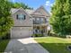 Beautiful two story home boasting a green lawn and stone details at 4022 Roberts Crest Dr, Suwanee, GA 30024
