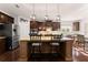 Gourmet kitchen featuring stainless steel appliances, granite countertops, and dark wood cabinetry at 4022 Roberts Crest Dr, Suwanee, GA 30024