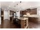 Spacious kitchen with dark wood cabinets, granite countertops, and stainless steel appliances at 4022 Roberts Crest Dr, Suwanee, GA 30024