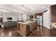 Open-concept kitchen featuring granite countertops, stainless steel appliances, and a central island at 4022 Roberts Crest Dr, Suwanee, GA 30024