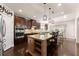 Beautiful open kitchen with an island, modern appliances, and dark wood cabinetry at 4022 Roberts Crest Dr, Suwanee, GA 30024