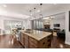 Bright open-concept kitchen with an island, granite countertops, and stainless appliances at 4022 Roberts Crest Dr, Suwanee, GA 30024