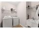 This laundry room includes a washer, dryer, utility sink, and ample storage space on the wire shelving at 4022 Roberts Crest Dr, Suwanee, GA 30024
