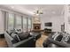 Inviting living room with stone fireplace, plush seating, and large windows for natural light at 4022 Roberts Crest Dr, Suwanee, GA 30024