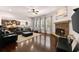 Open living room features a stone fireplace, hardwood floors, and abundant natural light at 4022 Roberts Crest Dr, Suwanee, GA 30024