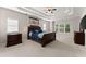 Spacious main bedroom with tray ceilings, ceiling fan, carpet floors, and dark wood furniture at 4022 Roberts Crest Dr, Suwanee, GA 30024