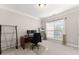 Bright home office space with neutral carpet and a large window for natural light at 4022 Roberts Crest Dr, Suwanee, GA 30024