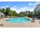 Community pool with sun loungers, mature trees, and clear blue skies for a relaxing outdoor experience at 4022 Roberts Crest Dr, Suwanee, GA 30024