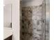 Bathroom shower with patterned gray tile walls and a glass enclosure at 4022 Roberts Crest Dr, Suwanee, GA 30024
