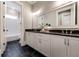 Stylish bathroom features black marble floors, white cabinets and a long vanity with dual sinks and a big mirror at 00 Memory Ln, Canton, GA 30115