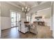 Bright dining room with hardwood floors, wainscoting, and a stylish chandelier over the wooden dining table at 00 Memory Ln, Canton, GA 30115