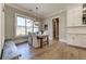 Cozy dining area with natural light, white cabinets, wood floors, and views of the backyard at 00 Memory Ln, Canton, GA 30115
