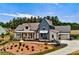 Exterior shot of a modern farmhouse featuring a large front yard with fresh landscaping and a charming front porch at 00 Memory Ln, Canton, GA 30115