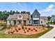 Beautifully landscaped home with a combination of light siding and gray accents, complemented by a well-manicured lawn at 00 Memory Ln, Canton, GA 30115