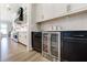 Stylish kitchen featuring sleek black and white cabinetry, modern appliances, and open access to dining area at 00 Memory Ln, Canton, GA 30115