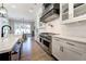 Modern kitchen features stainless steel appliances, white cabinets, a large island, and a view of the dining area at 00 Memory Ln, Canton, GA 30115