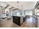Spacious open kitchen with island seating, stainless appliances, and view into the living room and dining area at 00 Memory Ln, Canton, GA 30115