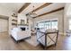 Bright living room featuring a stone fireplace, wood beams, a modern chandelier, and white furnishings at 00 Memory Ln, Canton, GA 30115