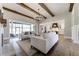 Bright living room with beamed ceilings, a fireplace, and a sliding door providing natural light and outdoor access at 00 Memory Ln, Canton, GA 30115