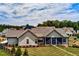 Rear view of the property highlighting the screened-in porch and the expansive backyard with mature trees at 00 Memory Ln, Canton, GA 30115