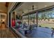Inviting screened porch with a brick fireplace, ceiling fans, and an outdoor living area overlooking the backyard at 00 Memory Ln, Canton, GA 30115