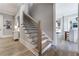 Elegant staircase with wooden steps, black metal railings, and hardwood floors leading to the upper level at 00 Memory Ln, Canton, GA 30115