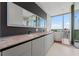 Modern bathroom boasts a soaking tub, floor-to-ceiling window, double vanity with stunning countertops and stylish fixtures at 1065 Peachtree Ne St # 3504, Atlanta, GA 30309