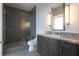 Modern bathroom with glass-enclosed shower, stone vanity, and updated lighting at 1065 Peachtree Ne St # 3504, Atlanta, GA 30309