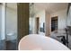 A luxurious bathroom is complete with soaking tub, glass enclosed shower with unique stone floor, and double vanity at 1065 Peachtree Ne St # 3504, Atlanta, GA 30309