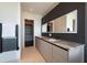 A sleek bathroom features a double vanity with marble countertops, minimalist design, and modern black fixtures at 1065 Peachtree Ne St # 3504, Atlanta, GA 30309