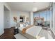 The spacious bedroom has floor-to-ceiling windows, neutral tones, and modern decor for a comfortable, stylish retreat at 1065 Peachtree Ne St # 3504, Atlanta, GA 30309