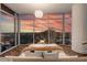 Primary bedroom boasts breathtaking sunset views through large windows and stylish decor at 1065 Peachtree Ne St # 3504, Atlanta, GA 30309