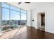 Bright bedroom features floor-to-ceiling windows with city views and a private bathroom at 1065 Peachtree Ne St # 3504, Atlanta, GA 30309