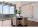 Bright dining room with hardwood floors, modern lighting and stunning city views through large windows at 1065 Peachtree Ne St # 3504, Atlanta, GA 30309