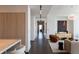 A long hallway leading into a living room with modern furniture and a large painting at 1065 Peachtree Ne St # 3504, Atlanta, GA 30309