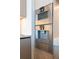A modern kitchen features stainless steel oven and coffee machine appliances built into wooden cabinetry at 1065 Peachtree Ne St # 3504, Atlanta, GA 30309