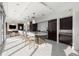 Bright kitchen featuring a large island with counter seating, modern lighting, and white tile flooring at 1065 Peachtree Ne St # 3504, Atlanta, GA 30309