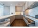 Modern kitchen featuring marble countertops, dark hardwood floors, and sleek, handleless cabinetry at 1065 Peachtree Ne St # 3504, Atlanta, GA 30309