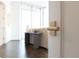 Modern door handle opens to a bright living space and city views beyond at 1065 Peachtree Ne St # 3504, Atlanta, GA 30309