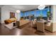 Spacious open-concept living room with floor to ceiling windows and hardwood floors with city views at 1065 Peachtree Ne St # 3504, Atlanta, GA 30309
