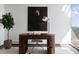 Modern home office featuring a wooden desk with a lamp, chair, house plant, and abstract wall art at 1065 Peachtree Ne St # 3504, Atlanta, GA 30309