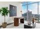 Home office featuring city views and modern desk setup by large windows at 1065 Peachtree Ne St # 3504, Atlanta, GA 30309