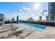 Relaxing rooftop pool with lounge chairs, umbrellas, and cityscape views at 1065 Peachtree Ne St # 3504, Atlanta, GA 30309