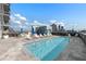 Inviting rooftop pool with lounge chairs, dining area, and blue umbrellas at 1065 Peachtree Ne St # 3504, Atlanta, GA 30309