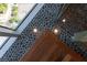 Unique stone floor and wooden details highlight the luxury shower, offering a spa-like experience with upscale design at 1065 Peachtree Ne St # 3504, Atlanta, GA 30309