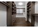 Spacious walk-in closet with custom shelving, drawers, and wood flooring at 1065 Peachtree Ne St # 3504, Atlanta, GA 30309